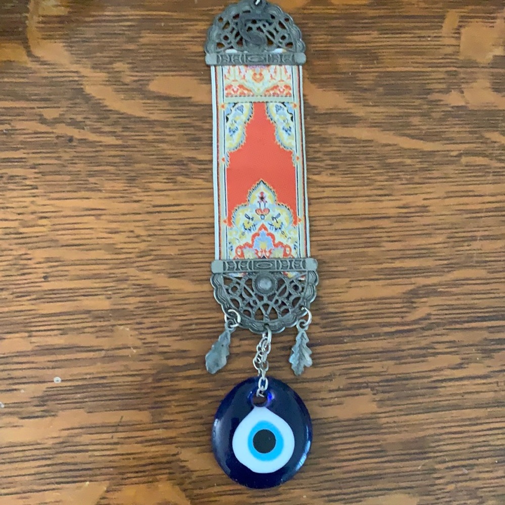 Evil eye with brass and tapestry